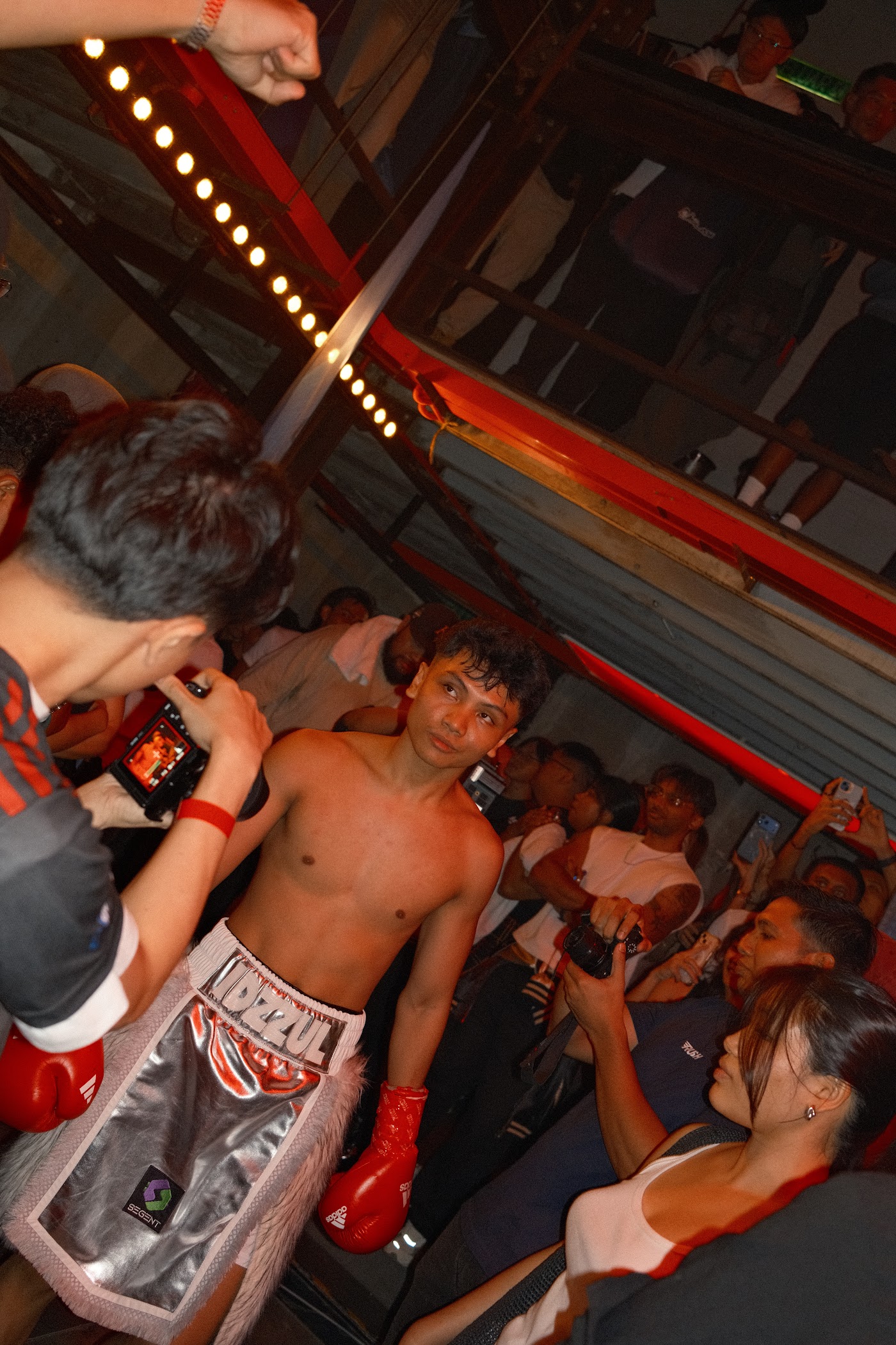 Fighter walking through the crowd as people film and photograph him