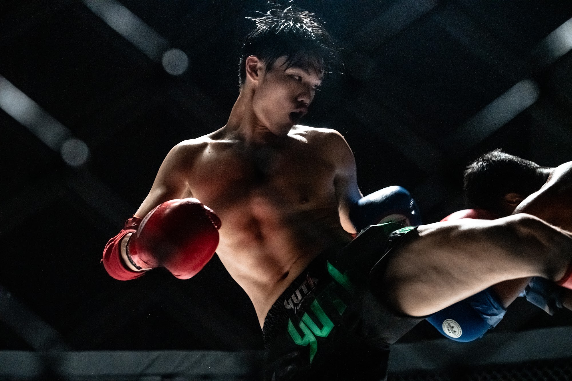 Fighter mid-strike inside the cage
